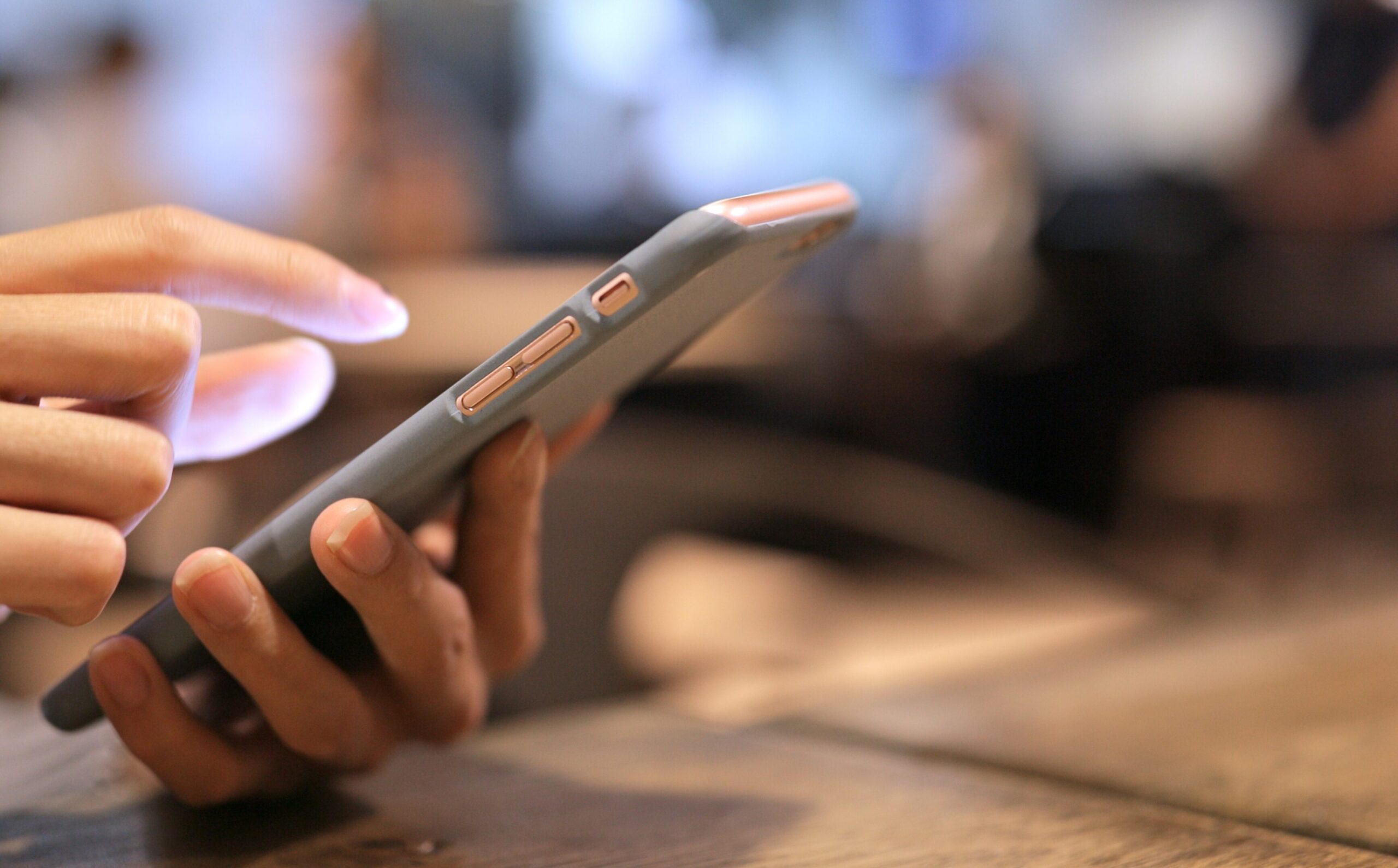 Woman typing on a mobile phone screen