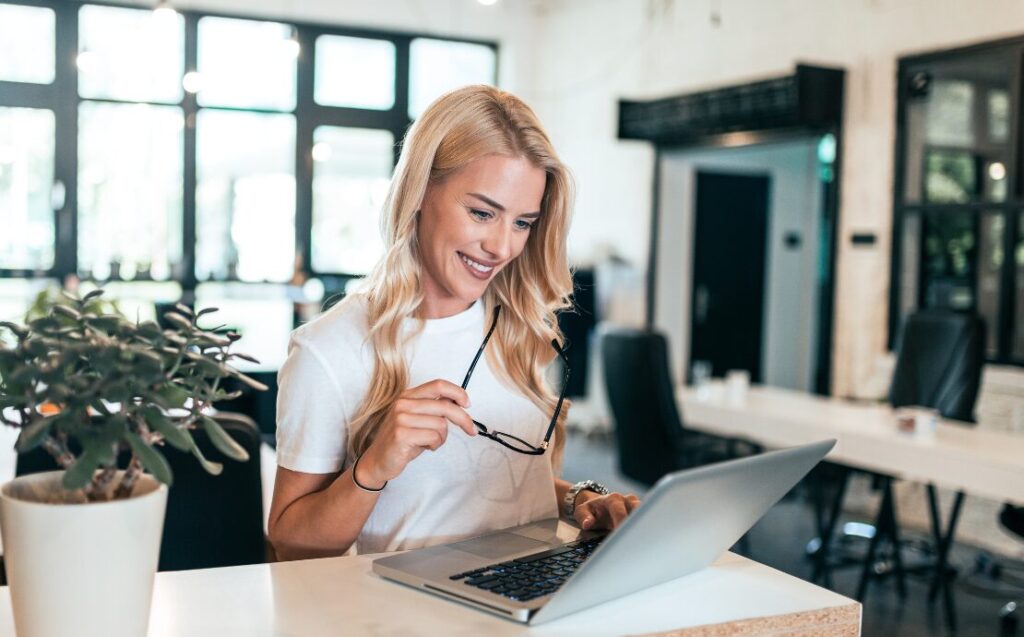 Woman smiling at laptop