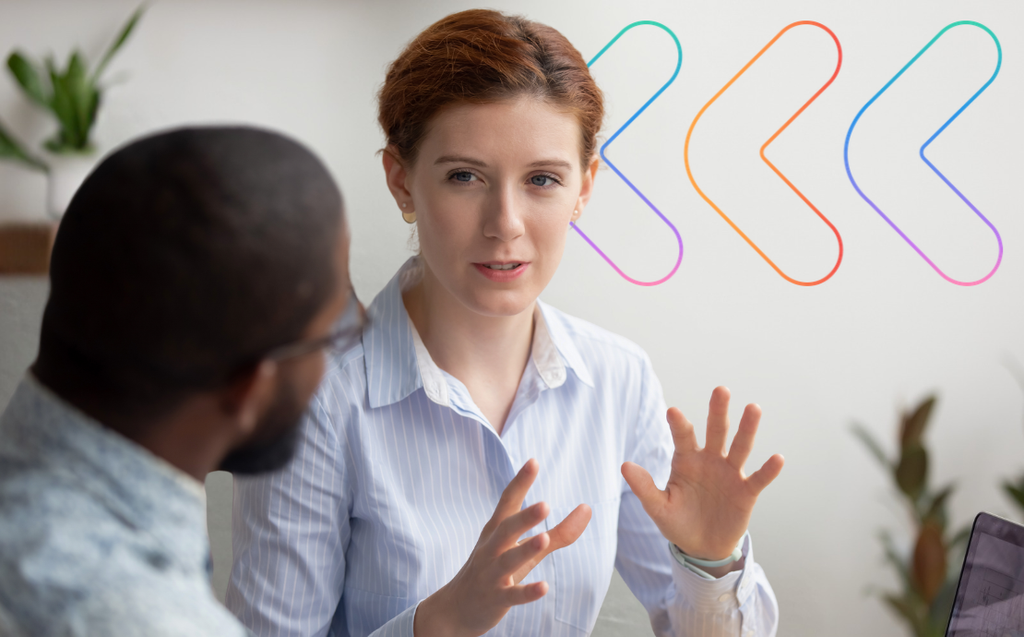 Two colleagues having a face-to-face conversation in an office
