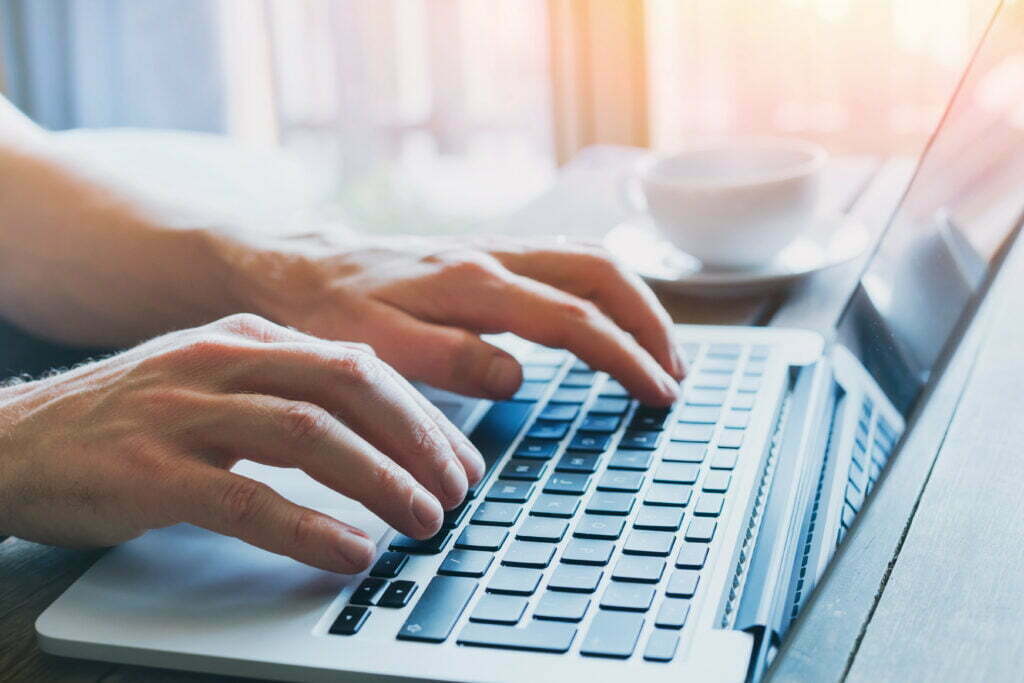 close up of hands of business person working on computer